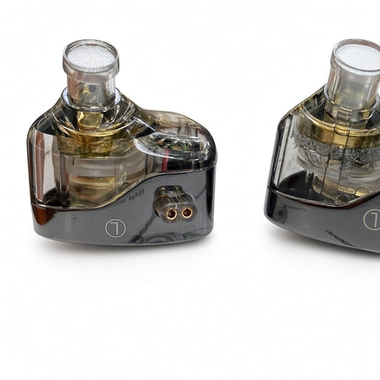 Close-up of KZ Castor Harman Target Improved Bass edition in-ear monitor showing translucent black shell, dual dynamic drivers, and 2-pin connector.