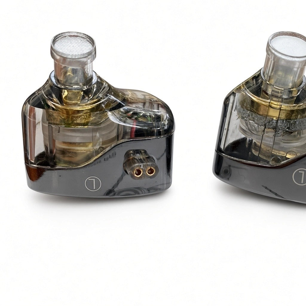 Close-up of KZ Castor Harman Target Improved Bass edition in-ear monitor showing translucent black shell, dual dynamic drivers, and 2-pin connector.